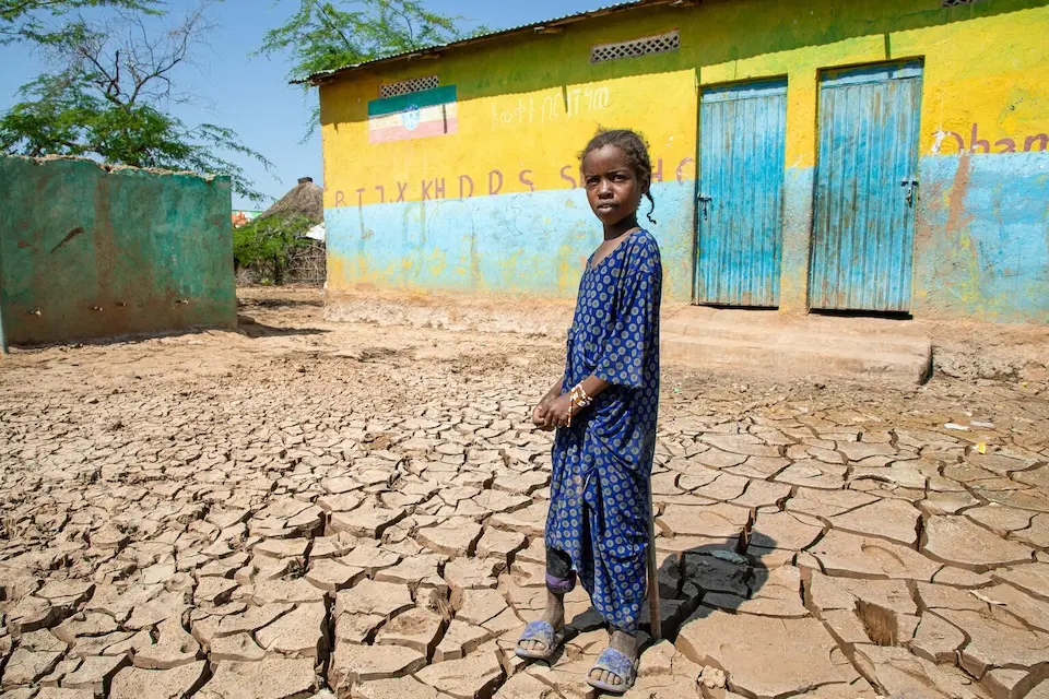 Bintu, 9, stands on cracked, dry ground in the Somali region of Ethiopia.