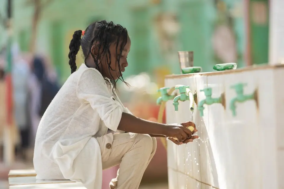Naba washes her hands at a UNICEF safe learning space in Kassala, Sudan.