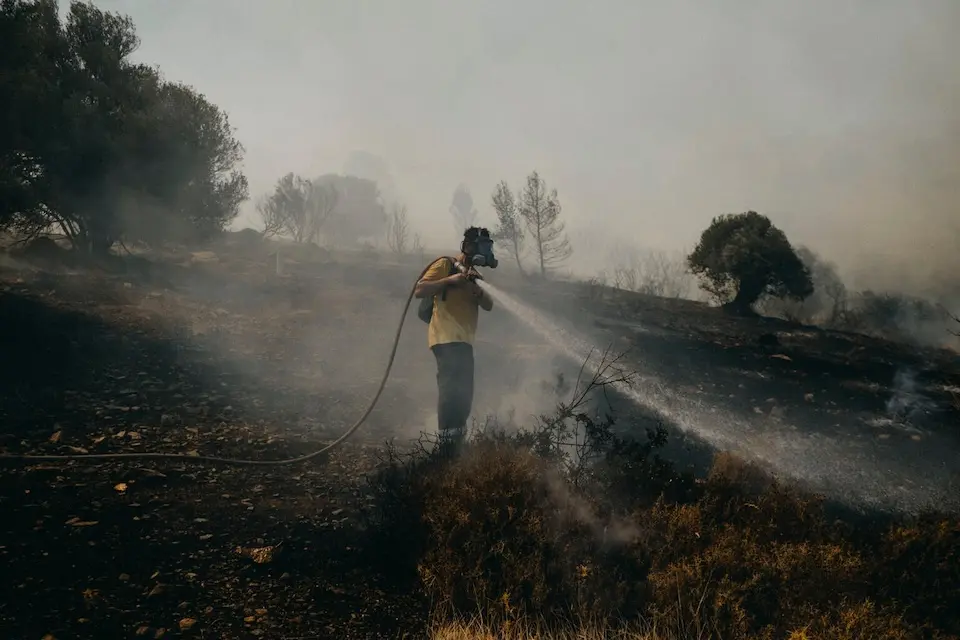 A volunteer firefighter helps put out a fire in the Plaka area in Keratea, 40 kilometers southeast of Athens, Greece, in 2021.
