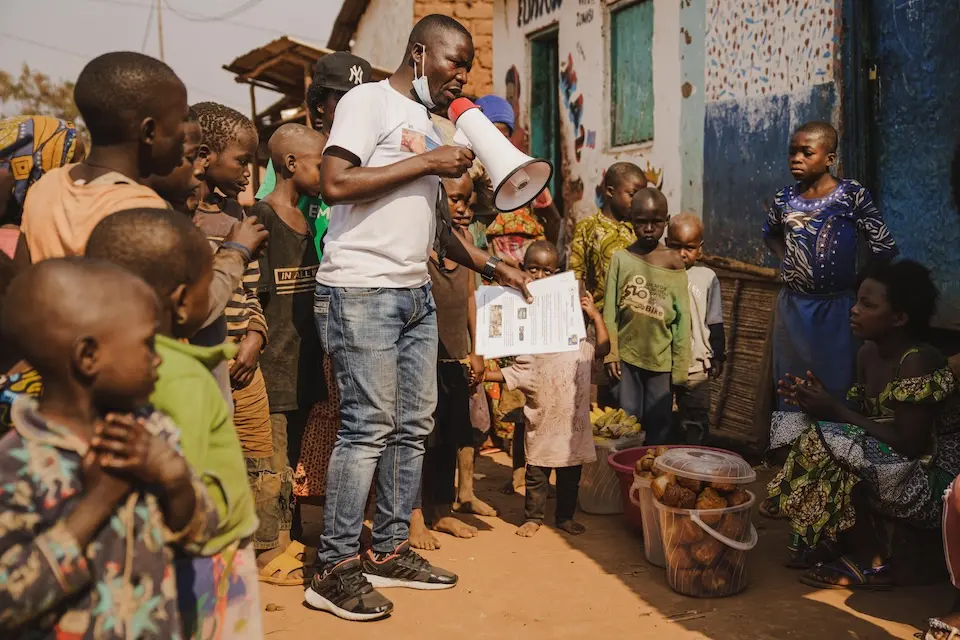 Innocent Murula, a UNICEF-supported community outreach worker, uses his megaphone to raise community awareness about mpox in Kamanyola, South Kivu province, DRC, on July 25, 2024.