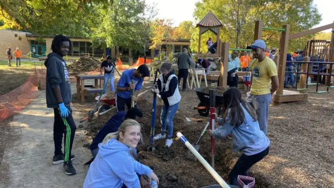 Members of the UNICEF Club at the University of Michigan building a playground at a local elementary school, one of the Club's many community service projects. ©️ Photo provided by UNICEF-UM