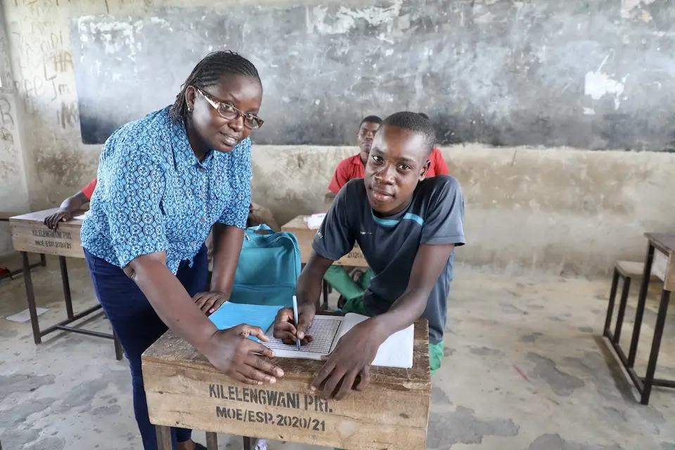 Mohamed, 17, with Ms. Catharine from WERK Kenya, the implementing partner supporting the back-to-school program in Tana River County, Kenya.