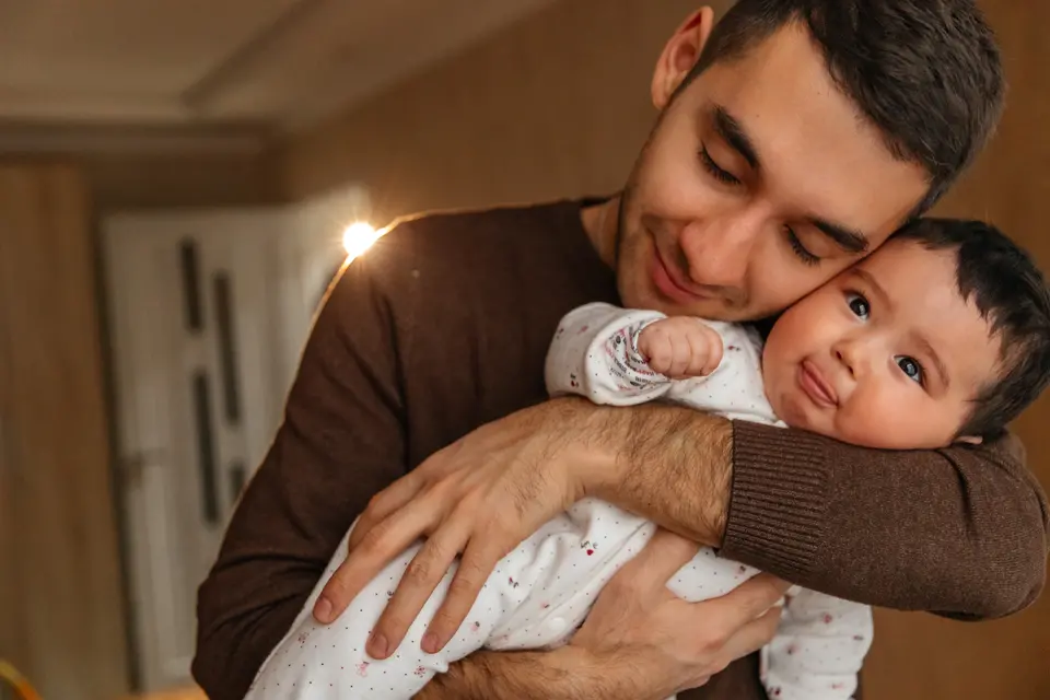 Father cradles infant