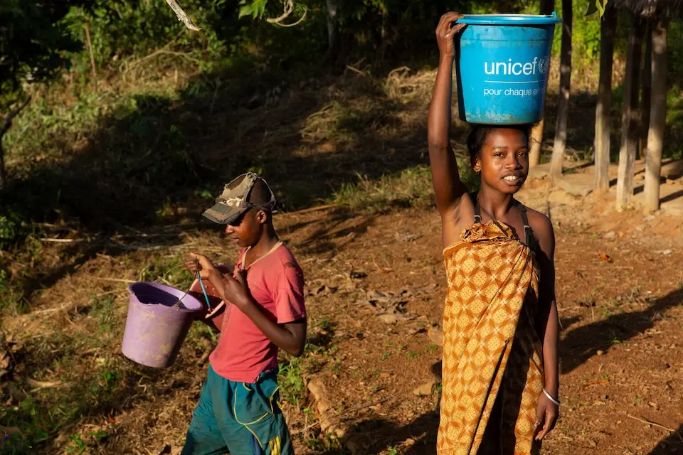 Women collect clean and safe water from a borehole built by UNICEF in the Tsiatosika village in Eastern Madagascar. The southeast region of Madagascar was hit in early 2022 by two consecutive cyclones — Batsirai and Emnati — followed by other tropical storms. Then in March 2023, Tropical Cyclone Freddy hit the region again.