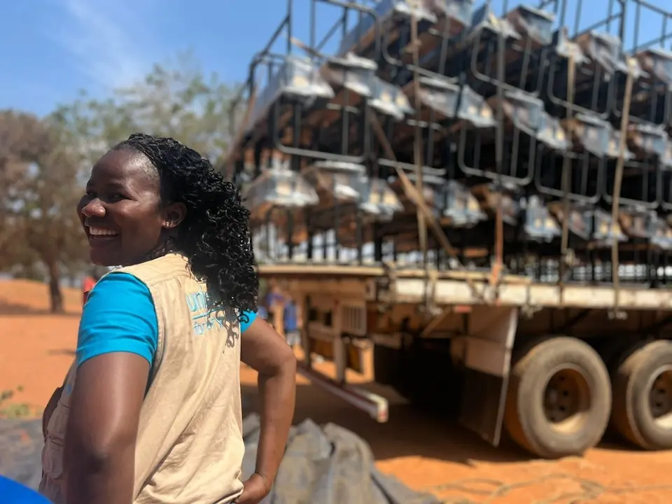 UNICEF's Annie Matson celebrates the arrival of new desks from the K.I.N.D. Fund at Bwengu Primary School in Malawi.