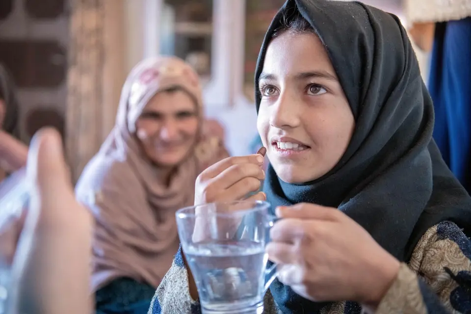 10-year-old Fatima takes folic acid at a UNICEF-supported household visit in Koshi village, Logar Province, central Afghanistan.