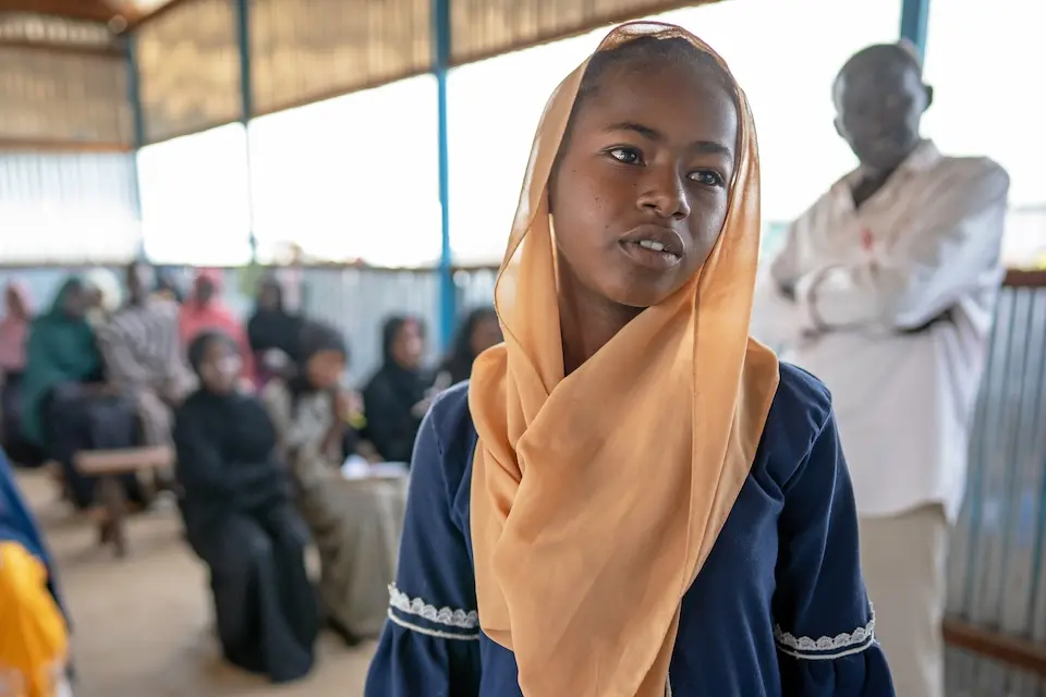 A young girl who fled conflict in Sudan attends a UNICEF-supported school at the Renk Transit Center in South Sudan.