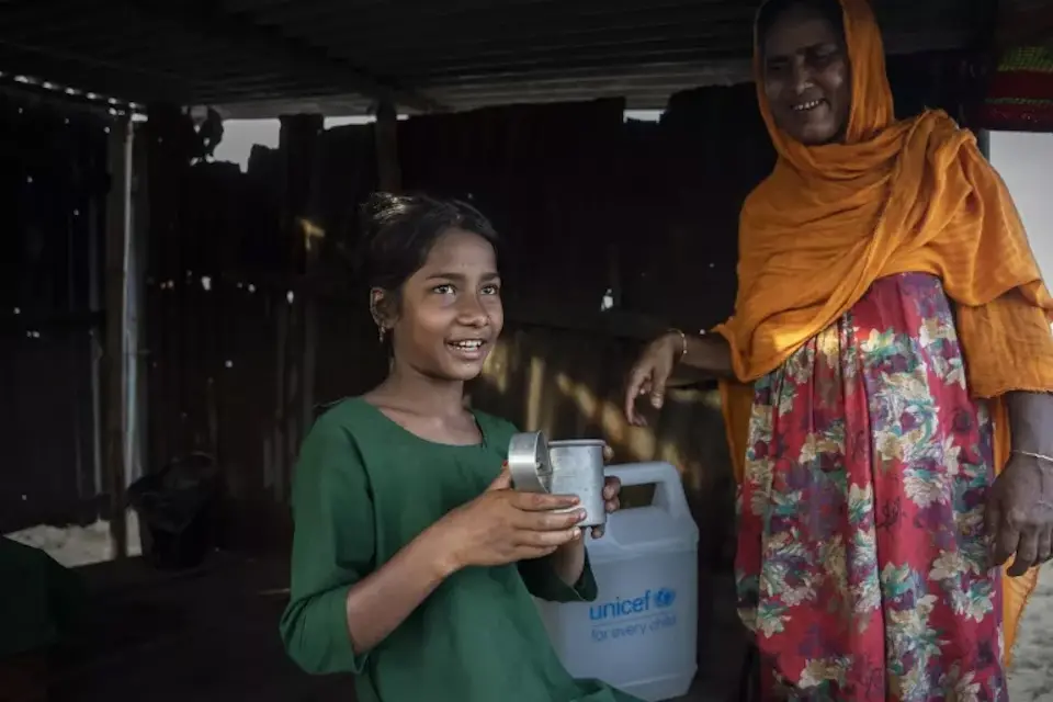 Ruksana, 9, who lives in Companygani village in Sylhet division, northeastern Bangladesh, holds a cup of safe water, purified with tablets distributed by UNICEF as part of an emergency response to catastrophic floods supported with flexible funding.