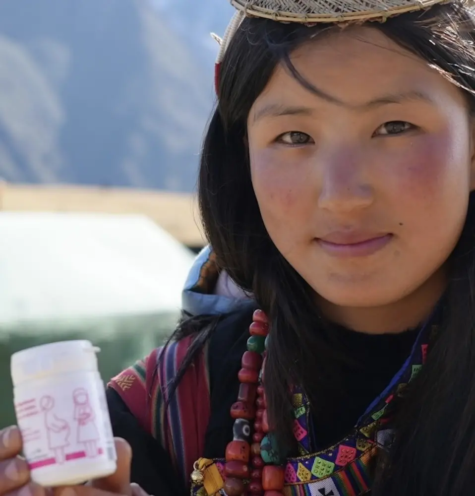 A pregnant Bhutanese woman holds nutrition supplements. © WFP Bhutan/2024/K Wangmo