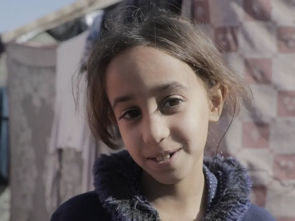 A child stands in front of a makeshift tent in the Gaza Strip in January 2025.
