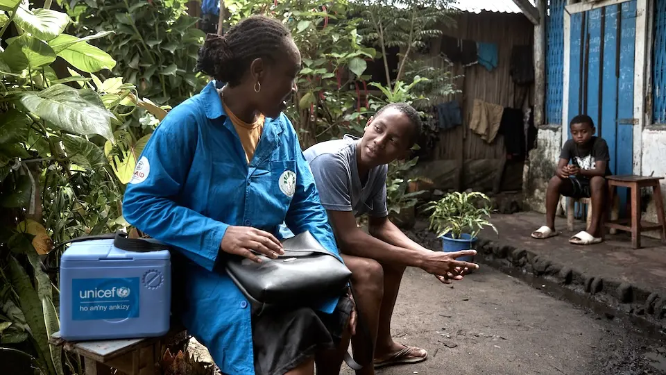 A UNICEF-supported community health worker in Analanjirofo, Fenerive Est,Madagascar visits with a family at their home.