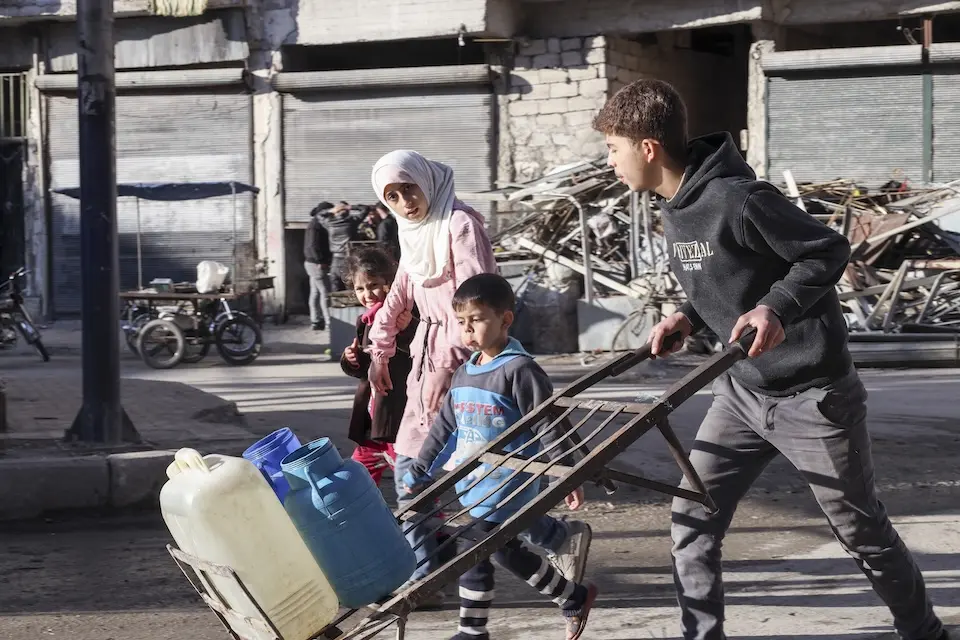 Children fetch water in Aleppo, Syria, on Dec. 14, 2024.