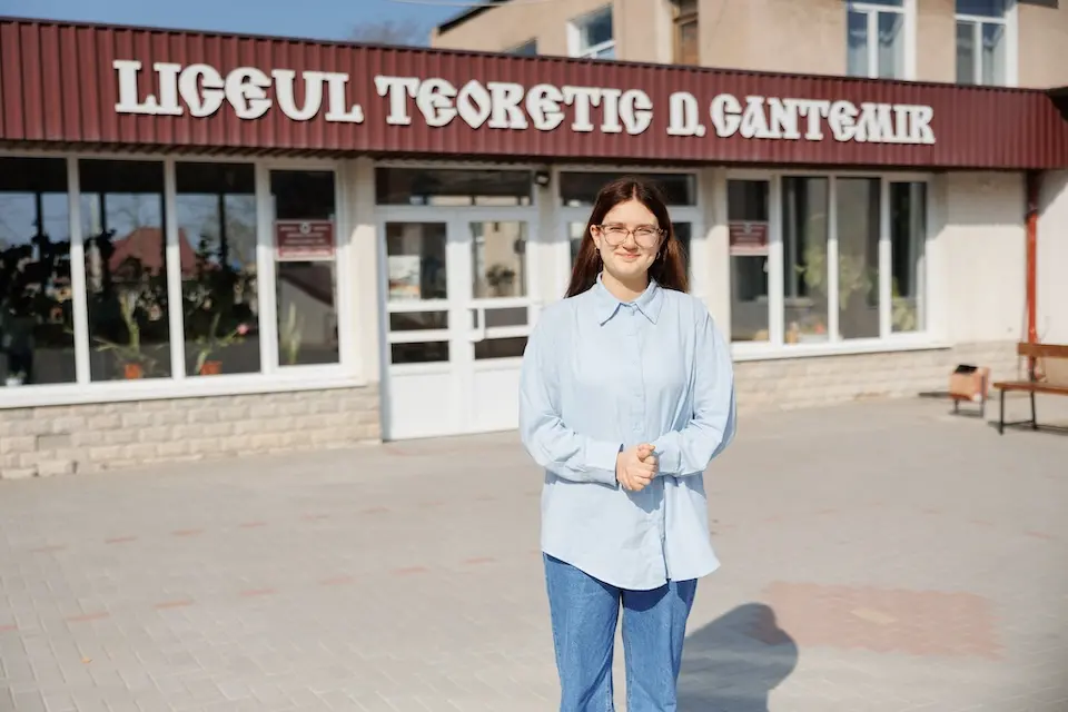 Nadejda, a 16-year-old Ukranian refugee, in front of Dimitrie Cantemir High School in Cahul, Moldova, where she attends an ECW-supported EDUTech lab.