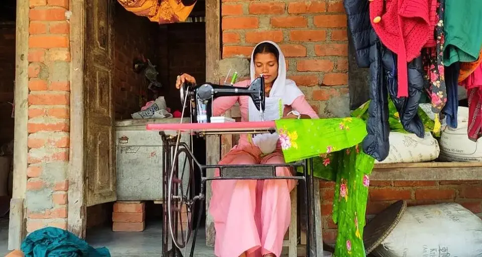 Sahira, 16, works at her sewing machine at her home in the Saptari district of southern Nepal.