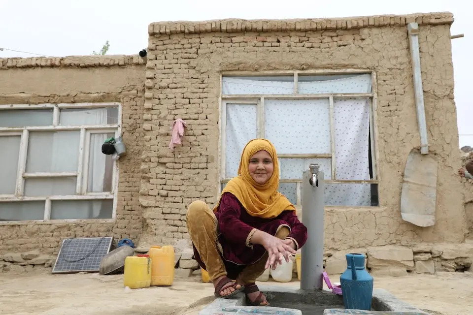 Zahra, 10, washes hands at a new water tap near her home in Hewad Mena, Maidan Wardak Province, Afghanistan.