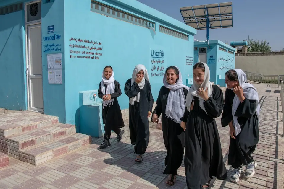 On June 15, 2023, a group of students walk into the newly constructed latrines at Mawlana Jalaluddin Mohammad Balkhi School in Mazar-i-Sharīf, Balkh Province, Afghanistan. 