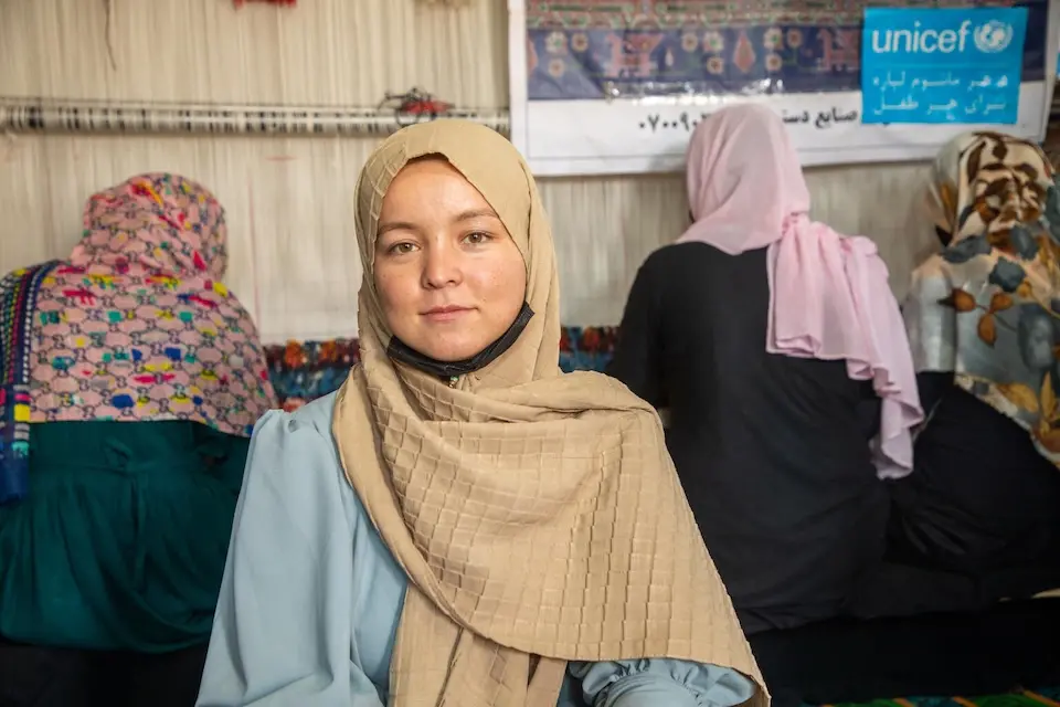In Herat province, Afghanistan, Ruqia participates in her carpet weaving vocational training program, supported by UNICEF with funding from the Government of Japan.
