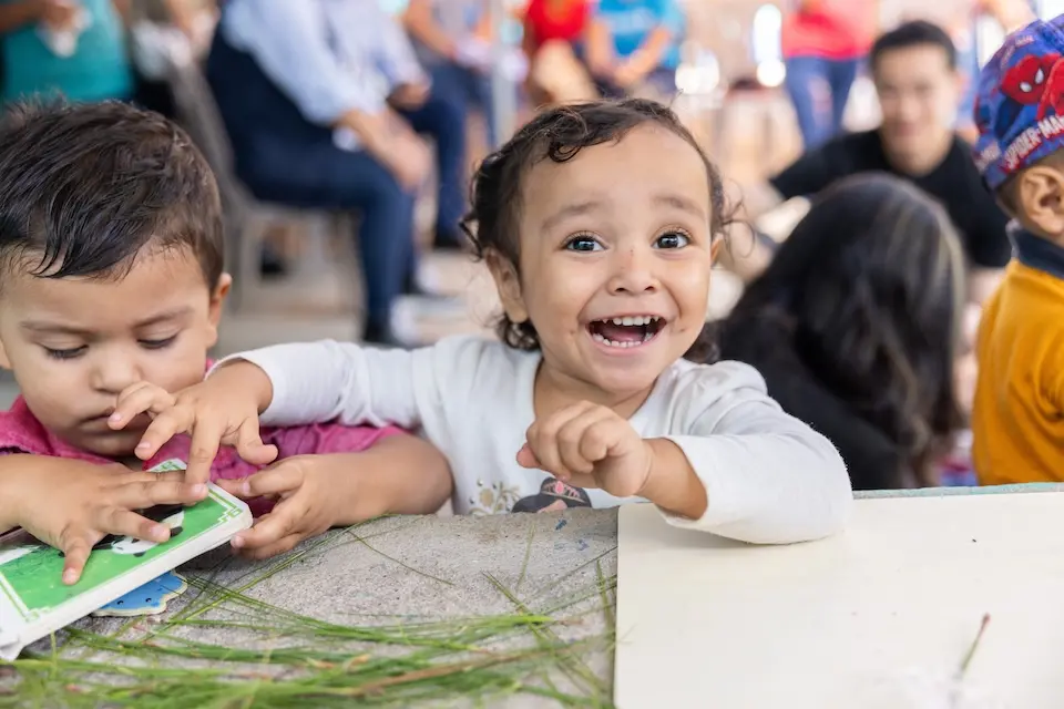 In Chiquimula, Guatemala, a 2-year-old girl beams while playing at a community center for comprehensive child development that is supported by UNICEF.