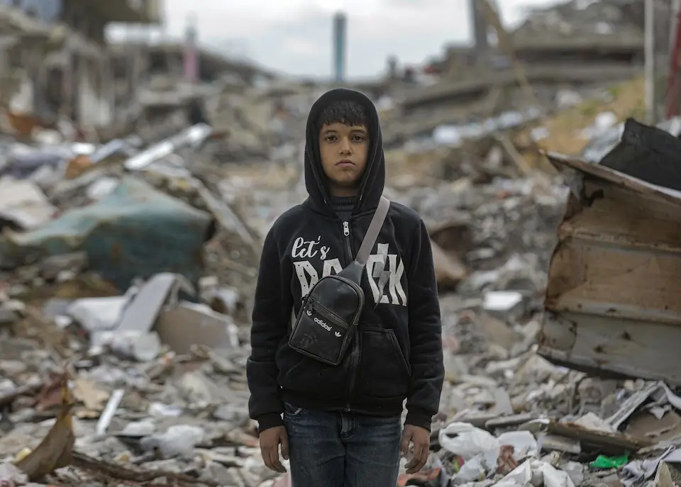 Qusay, 10, stands in the ruins of his hometown in northern Gaza on Feb. 7, 2025.