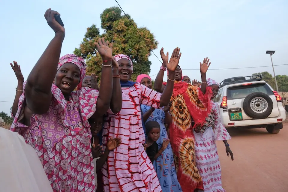 A group of mothers smile and clap to welcome visitors from UNICEF USA to their village Djende, near the town of Sedihou, located in Senegal's southwestern region of Casamance.