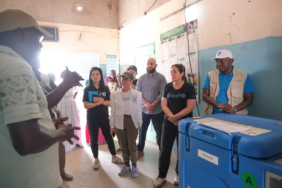 Yves Olivier Kassoka, second from left, Chief of the Field Office in Kolda, Senegal, joins the UNICEF USA delegation on a visit to a village health post in Dinguiraye.