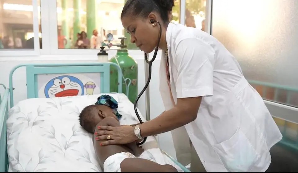 Dr. Florence S. Saint-Surin, head of the pediatric department at La Paix Hospital in Port-au-Prince, treats a young patient.