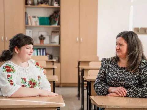 Marina, 15, with her mother Raisa, in a classroom at Marina's school in Moldova.