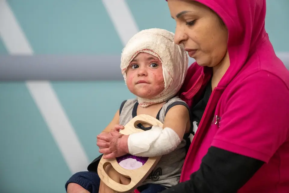 Injured in an Israeli air strike, 2-year-old Ivana sits on her mother's lap in a hospital in Beirut, Lebanon on Oct. 12, 2024.