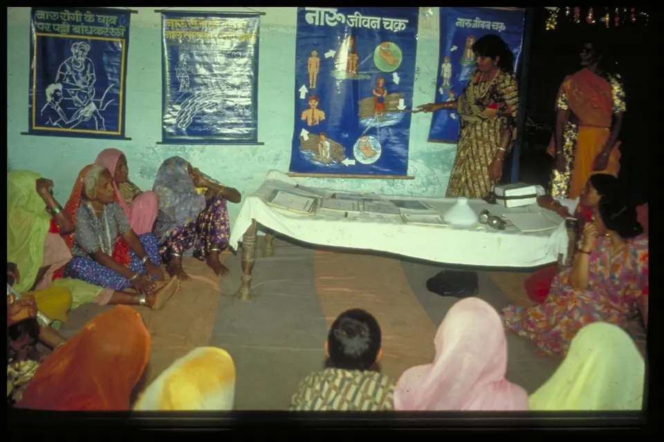 : A woman explains the life cycle of a Guinea worm as part of community education efforts in Rajasthan, India.