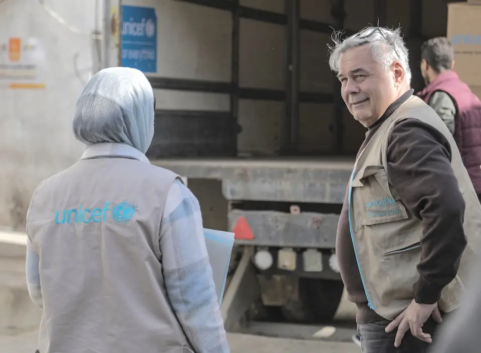 UNICEF staff pause as they unload trucks filled with essential medical supplies for Al Awda hospital in northern Gaza on Feb. 20, 2025.