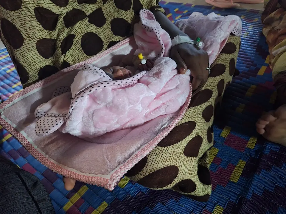 On Dec. 6, 2024 in Sudan, 19-year-old Yara [NAME CHANGED] sits in the courtyard of a hospital and holds her daughter three days after delivery.