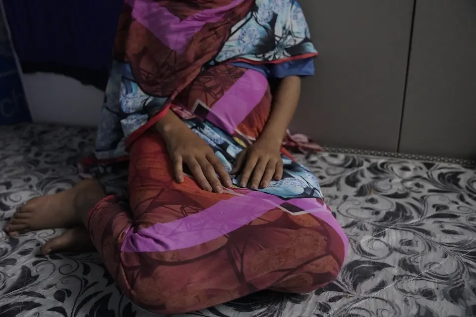 On Dec. 2, 2024 in Sudan, 16- year- old Dana [NAME CHANGED] rests on a mattress at a UNICEF office.