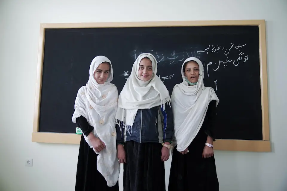 Fifth-grade students stand in front of the blackboard in their newly built classroom at Soroubi Girls’ School in Nazyan district, Nangarhar, Afghanistan.