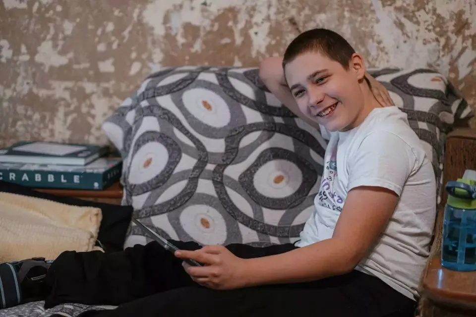 Nazar, 13, uses a tablet provided by UNICEF as part of a child-focused victim-assistance program in Ukraine.