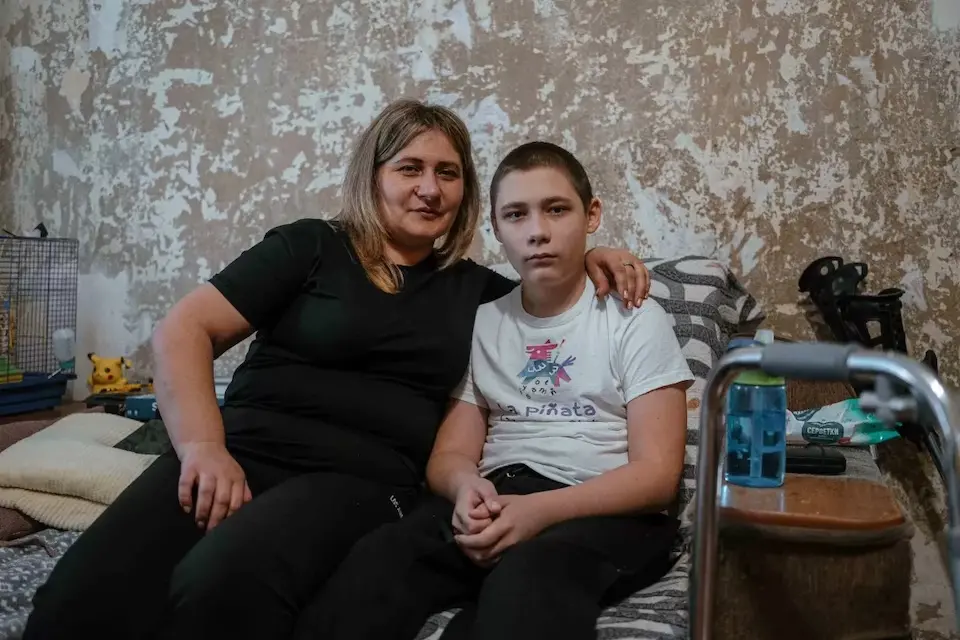 Nazar, 13, injured by an explosive remnant of war, at home with his mother in Nikopol, Kharkiv oblast, eastern Ukraine. 