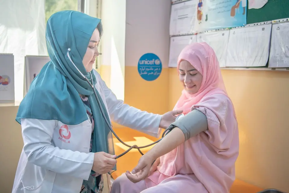 A pregnant woman has her blood pressure checked by a midwife at a UNICEF-supported health clinic in Darei Sadat village in Bamyan province, Afghanistan.