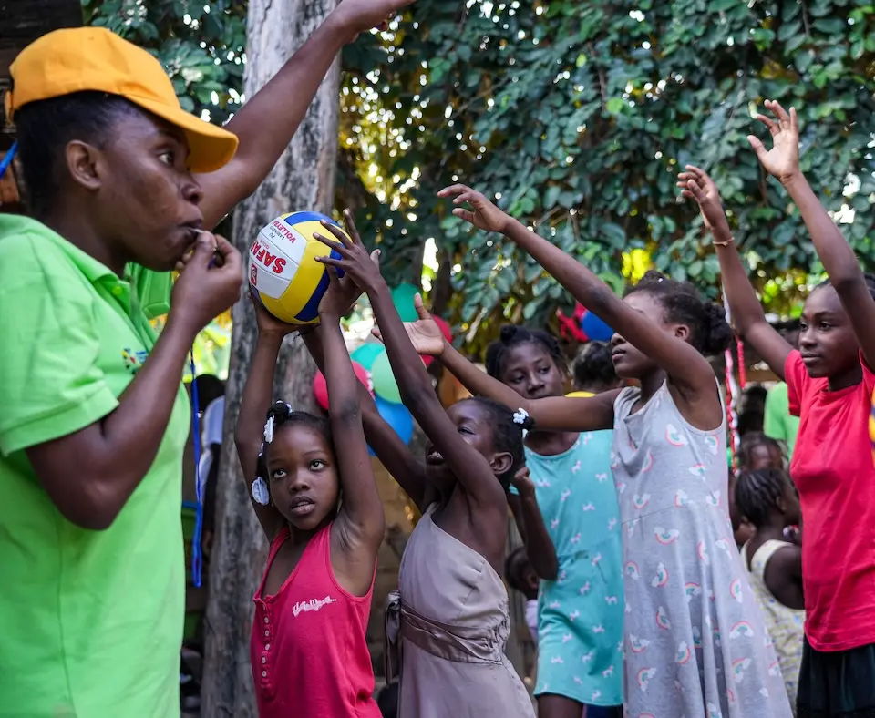 Children play games at a UNICEF-supported site for displaced families in Haiti.