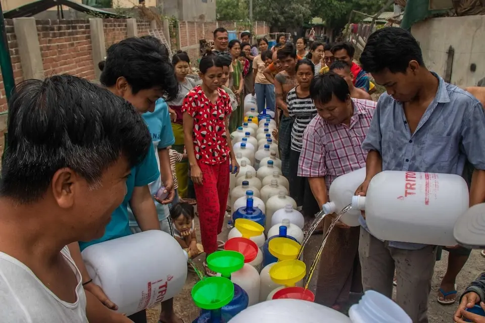On April 6, 2025, residents fill their water bottles at the UNICEF water distribution point at Oo Yin Kone ward, Aung Myay Thar Zan township, in Mandalay region, Myanmar.