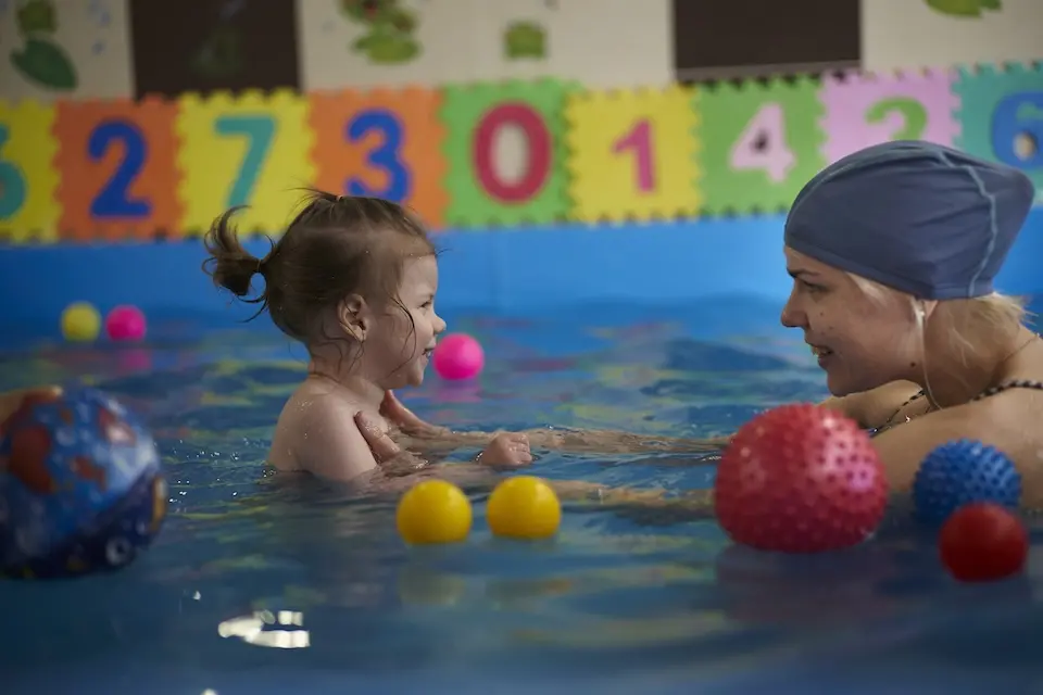 3-year-old child with disabilities plays during a UNICEF-supported aquatherapy session.