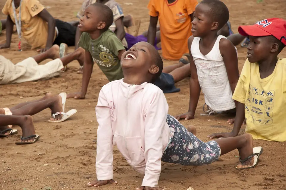 A young girl does yoga during a UNICEF-supported youth counseling session in Kenya.