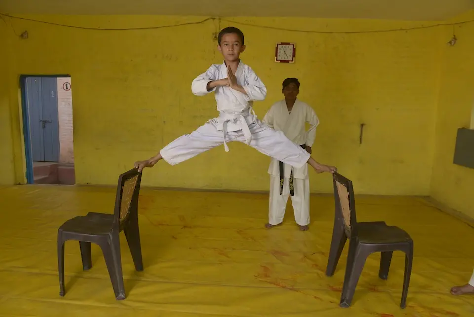 A boy in India demonstrates martial arts moves he learned in a UNICEF program.