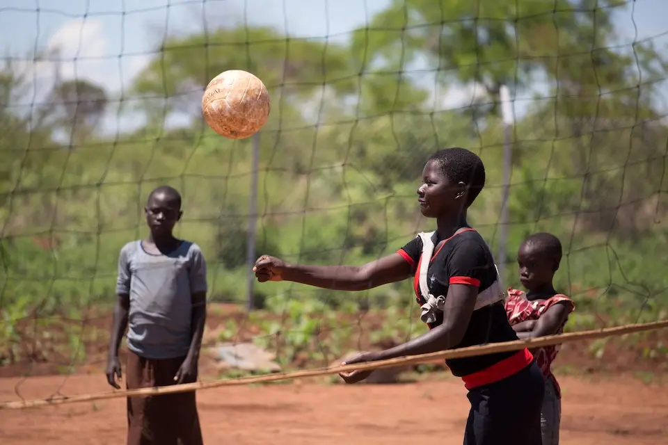 Refugee girls from South Sudan play volleyball at a UNICEF-supported settlement in Uganda.