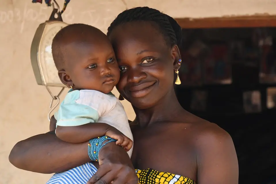 On Feb. 18, 2025, a mother holds her 10-month-old baby during a check-up by a UNICEF-supported visiting nurse in he village of Kafongo, in the North of Côte d’Ivoire.