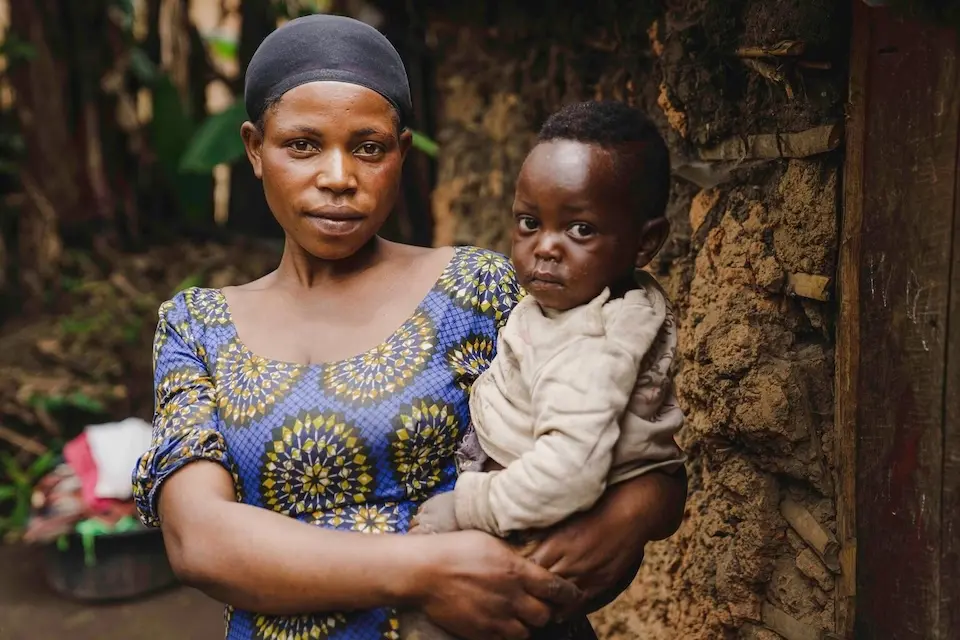 Displaced by violence in the DRC, a mother holds her baby in Bihambwe village, North Kivu province, on March 6, 2025.