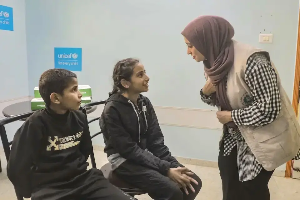 A brother and sister with hearing impairments receive new hearing aids from UNICEF in the Gaza Strip.