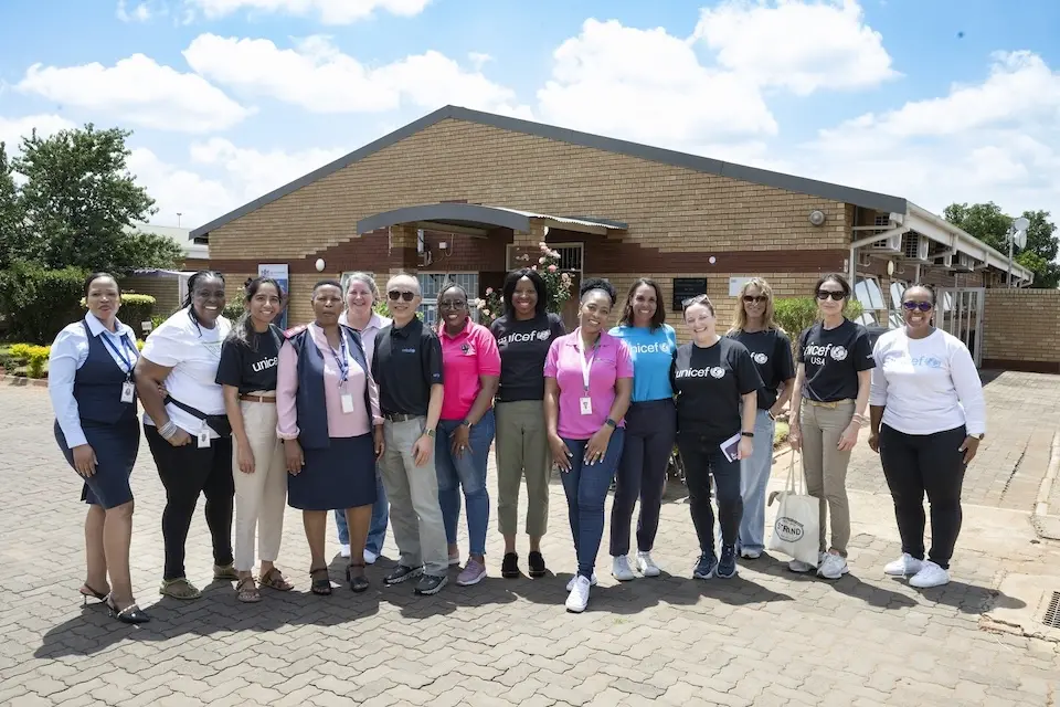 UNICEF team stands with health workers and administrators at a clinic in South Africa
