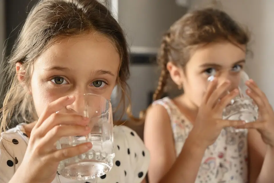 Candela and Amanda, from a family in Canelón Chico, Uruguay, drink water. 