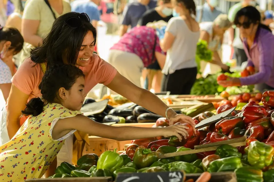 A mother and daughter, Alejandra and Julieta, buy their food at the neighborhood market in Parque del Plata, Uruguay. 