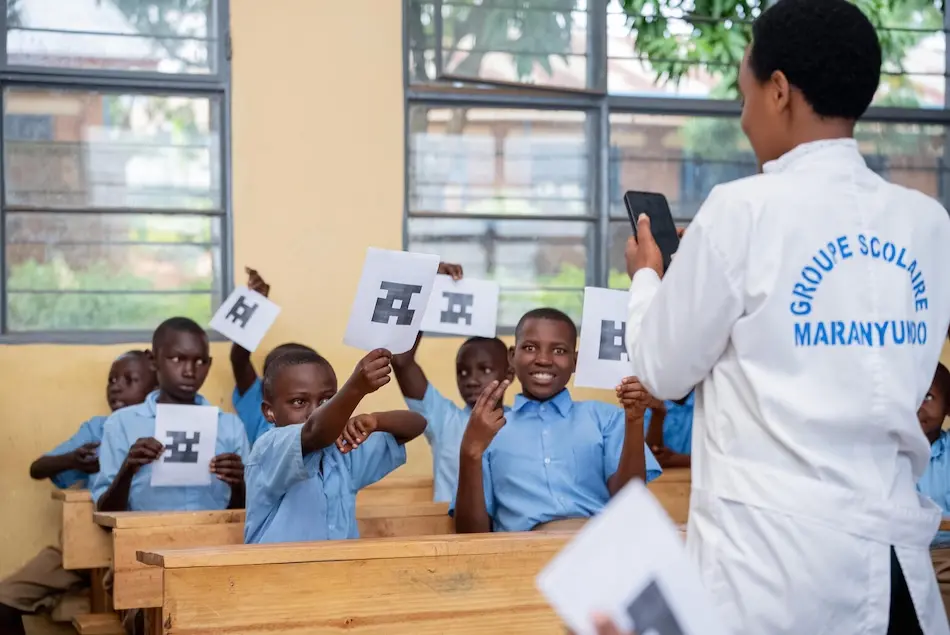 A teacher in Rwanda interacts with students using digital tools.