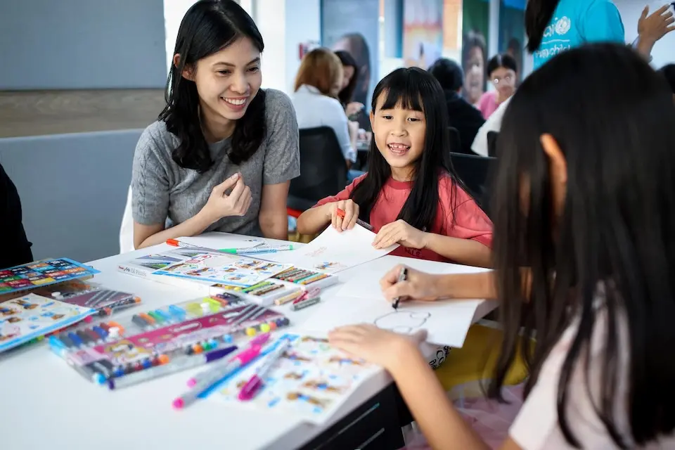 Children in Thailand play a game at a UNICEF Thailand Open House event
